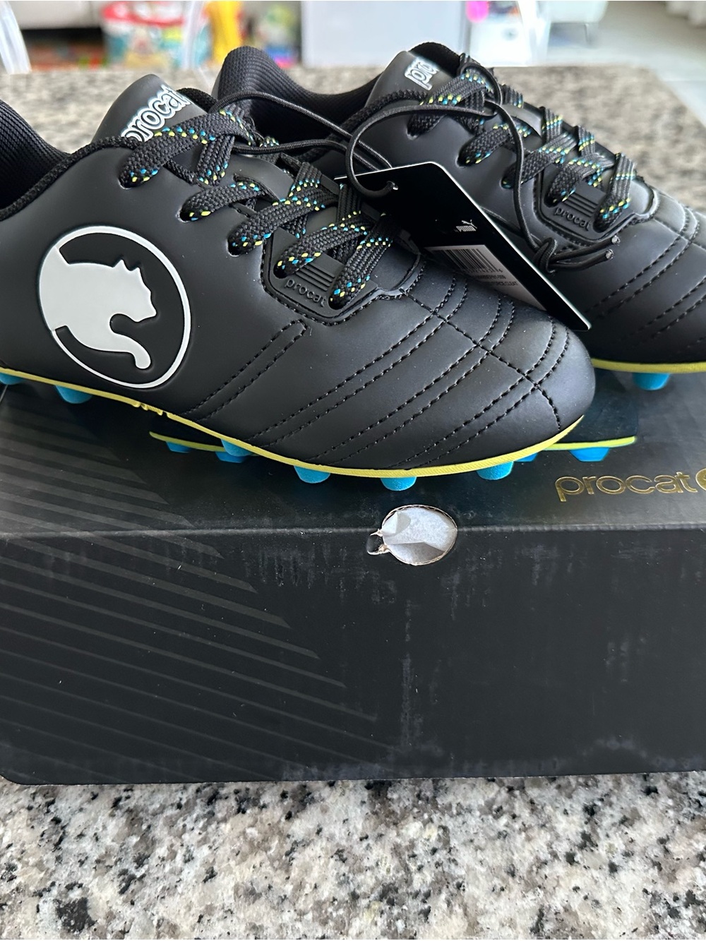 Puma Kids Black Soccer Cleats with Blue Studs and Yellow Accents